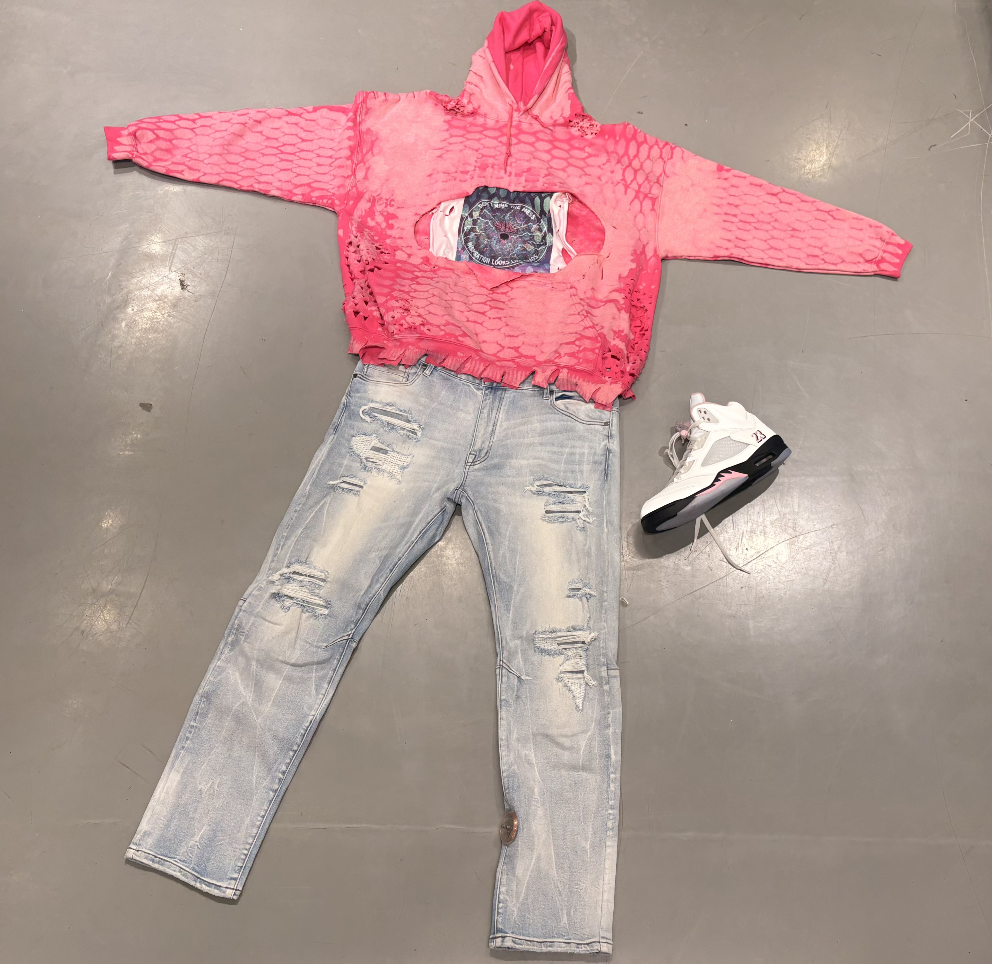 Pink distressed hoodie flat lay